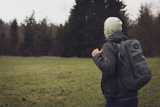 man with goruck backpack rucking in forest